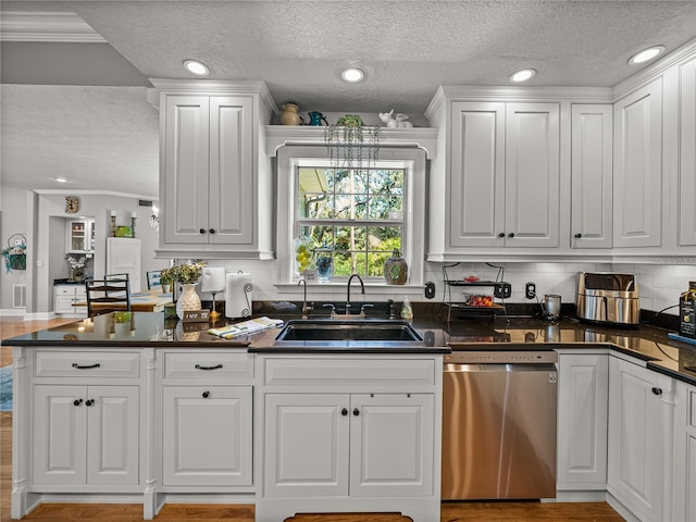 4611 Ackerly Way, Brandon, FL 33511 - kitchen with dishwasher, a textured ceiling, dark countertops, white cabinets, and backsplash