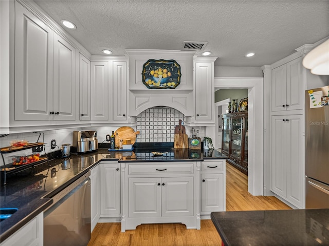4611 Ackerly Way, Brandon, FL 33511 - kitchen with dishwashing machine, freestanding refrigerator, light wood finished floors, white cabinetry, and recessed lighting