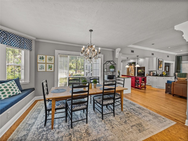 4611 Ackerly Way, Brandon, FL 33511 - dining area featuring healthy amount of natural light, light wood-style floors, crown molding, and a textured ceiling