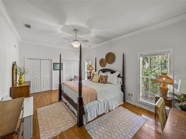 4611 Ackerly Way, Brandon, FL 33511 - bedroom with crown molding, multiple closets, wood finished floors, ceiling fan, and a textured ceiling