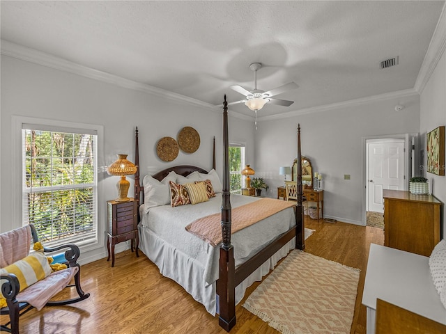 4611 Ackerly Way, Brandon, FL 33511 - bedroom featuring crown molding, wood finished floors, a ceiling fan, and a textured ceiling