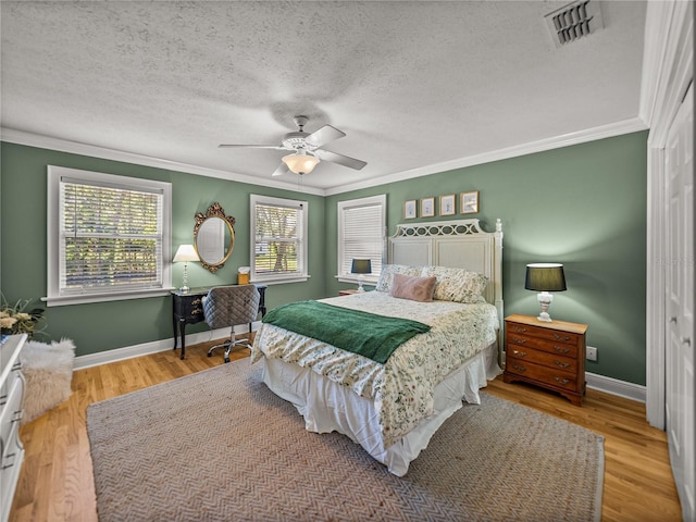 4611 Ackerly Way, Brandon, FL 33511 - bedroom featuring ornamental molding, wood finished floors, a textured ceiling, and a ceiling fan