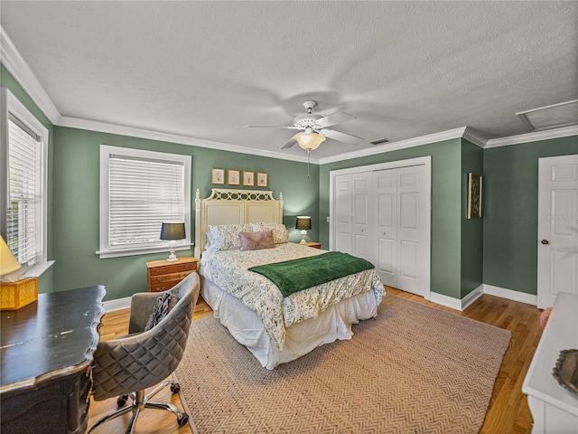4611 Ackerly Way, Brandon, FL 33511 - bedroom with wood finished floors, a closet, ceiling fan, a textured ceiling, and attic access