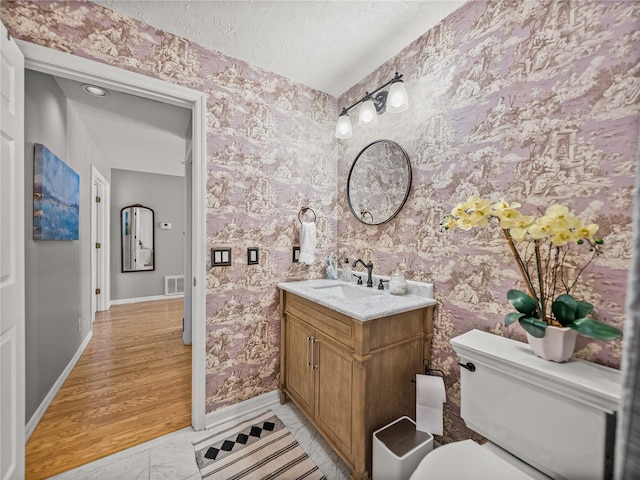 4611 Ackerly Way, Brandon, FL 33511 - bathroom with wallpapered walls, vanity, and a textured ceiling