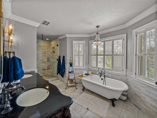 4611 Ackerly Way, Brandon, FL 33511 - full bath featuring a textured ceiling, tile walls, a stall shower, crown molding, and a freestanding bath