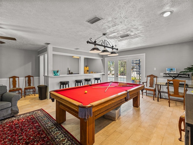 4611 Ackerly Way, Brandon, FL 33511 - recreation room with french doors, a textured ceiling, pool table, ceiling fan, and light wood-style flooring