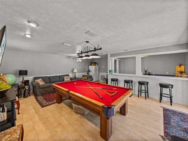 4611 Ackerly Way, Brandon, FL 33511 - recreation room with a textured ceiling, billiards, and wood finished floors