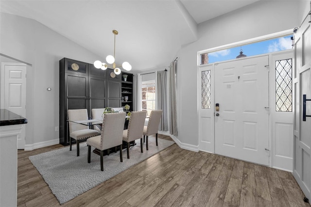 10421 Mesa Ln, Clermont, FL 34711 - dining area with wood finished floors, lofted ceiling, baseboards, and a chandelier