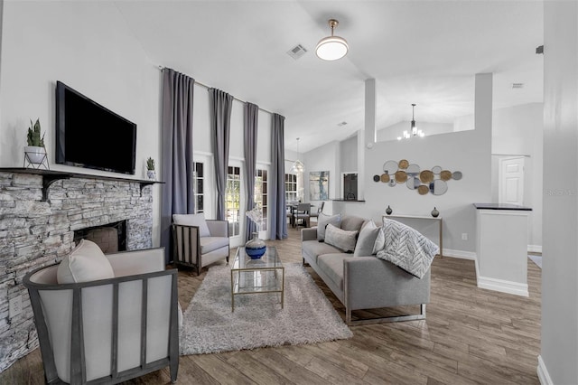 10421 Mesa Ln, Clermont, FL 34711 - living area featuring a chandelier, a fireplace, wood finished floors, baseboards, and high vaulted ceiling