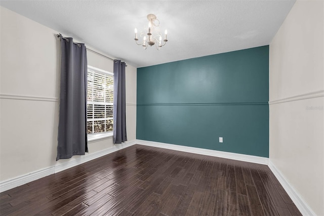 10421 Mesa Ln, Clermont, FL 34711 - unfurnished room with a chandelier, wood finished floors, and baseboards