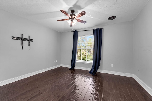 10421 Mesa Ln, Clermont, FL 34711 - spare room featuring dark wood-style flooring, ceiling fan, baseboards, and a textured ceiling