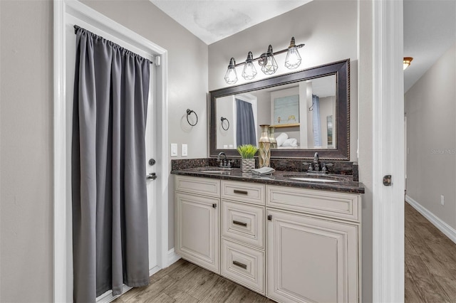 10421 Mesa Ln, Clermont, FL 34711 - full bathroom with double vanity, wood finished floors, and baseboards