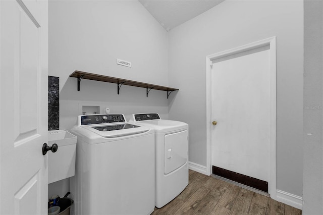 10421 Mesa Ln, Clermont, FL 34711 - laundry room featuring independent washer and dryer, wood finished floors, and baseboards