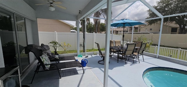 4500 Onorio St, New Port Richey, FL 34653 - sunroom with vaulted ceiling, ceiling fan, and outdoor dining area