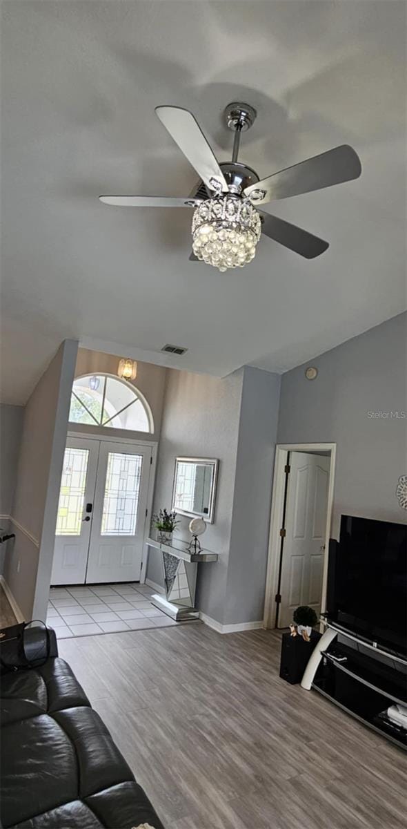 4500 Onorio St, New Port Richey, FL 34653 - living area with a ceiling fan, lofted ceiling, light wood finished floors, baseboards, and french doors