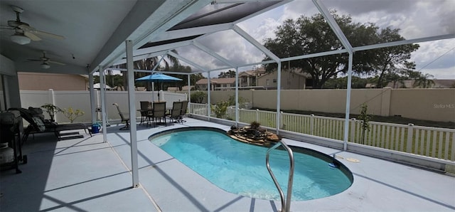 4500 Onorio St, New Port Richey, FL 34653 - view of pool featuring a fenced backyard, a patio area, ceiling fan, glass enclosure, and outdoor dining area