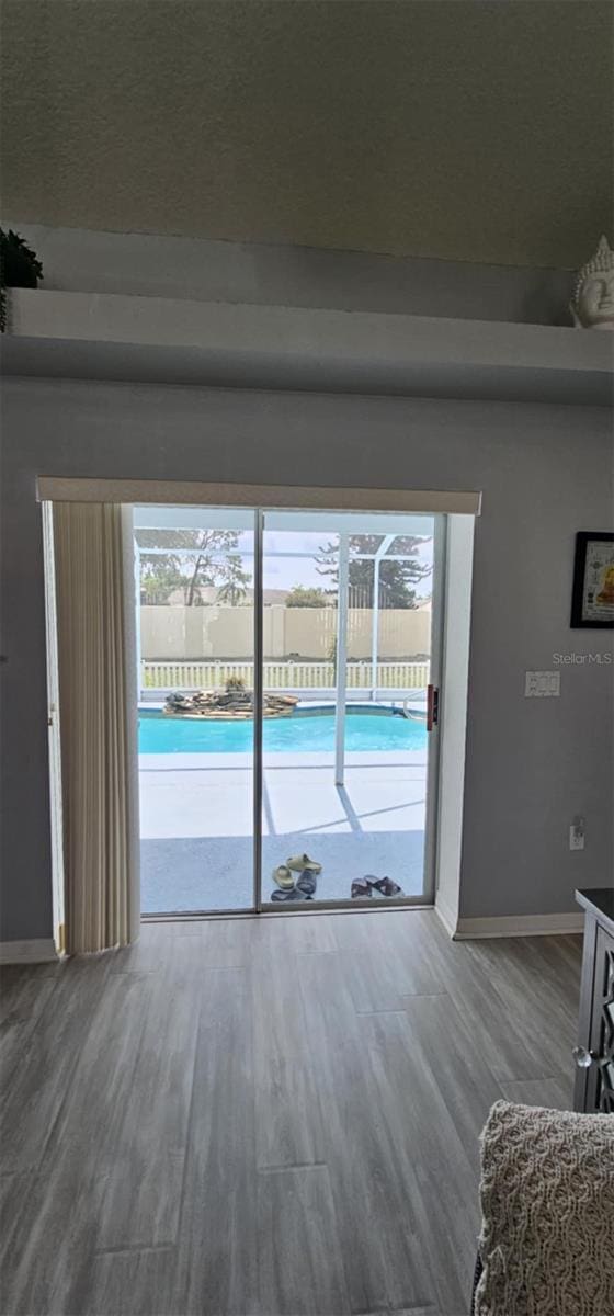 4500 Onorio St, New Port Richey, FL 34653 - living room featuring baseboards, plenty of natural light, and wood finished floors