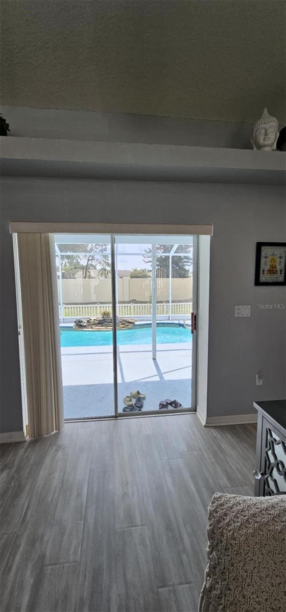 4500 Onorio St, New Port Richey, FL 34653 - living area featuring baseboards and wood finished floors