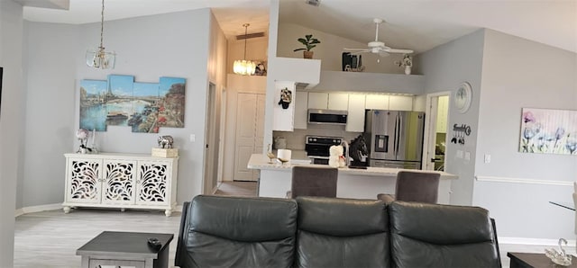 4500 Onorio St, New Port Richey, FL 34653 - kitchen featuring stainless steel appliances, a ceiling fan, high vaulted ceiling, light countertops, and light wood-type flooring