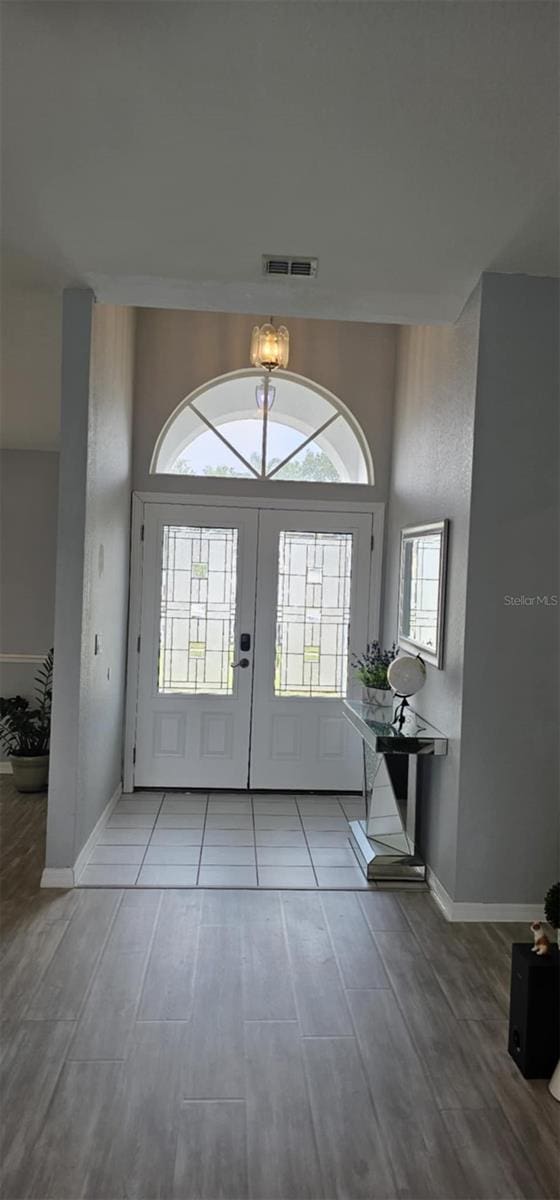 4500 Onorio St, New Port Richey, FL 34653 - foyer featuring light wood-type flooring, french doors, and baseboards