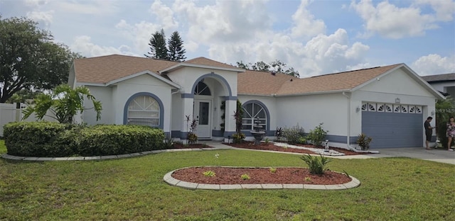 4500 Onorio St, New Port Richey, FL 34653 - mediterranean / spanish-style home with stucco siding, a garage, driveway, and a front lawn