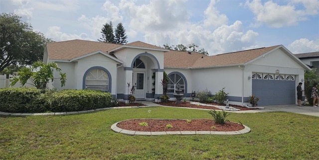 4500 Onorio St, New Port Richey, FL 34653 - mediterranean / spanish-style house featuring stucco siding, a garage, a front yard, concrete driveway, and roof with shingles