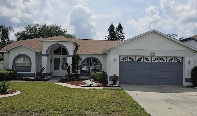 4500 Onorio St, New Port Richey, FL 34653 - view of front facade with stucco siding, a garage, a front yard, and driveway