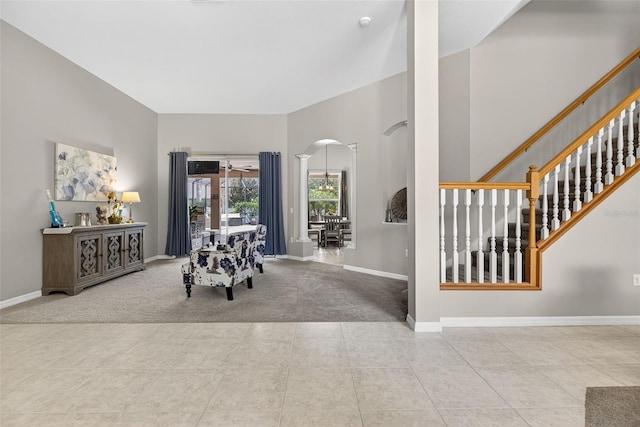 111 Falling Water Dr, Brandon, FL 33511 - tiled dining room featuring arched walkways, carpet floors, stairs, decorative columns, and ceiling fan
