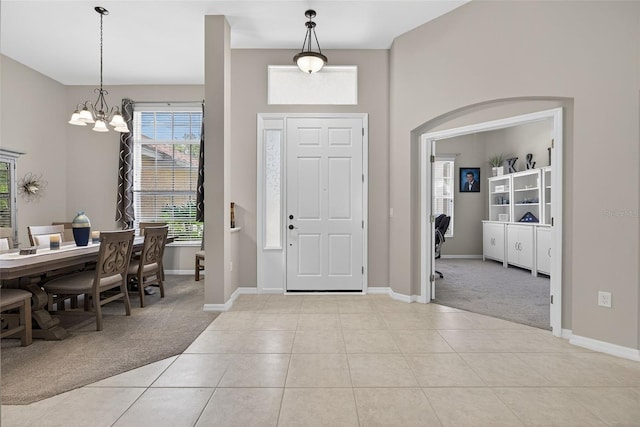 111 Falling Water Dr, Brandon, FL 33511 - foyer entrance with light colored carpet, a chandelier, and light tile patterned floors