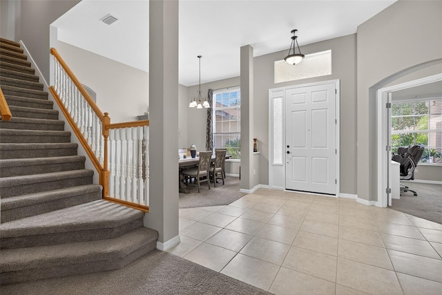 111 Falling Water Dr, Brandon, FL 33511 - entryway with light colored carpet, stairway, a chandelier, and light tile patterned floors