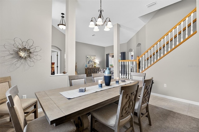 111 Falling Water Dr, Brandon, FL 33511 - tiled dining room with arched walkways, a chandelier, stairs, a high ceiling, and carpet