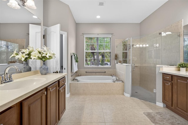 111 Falling Water Dr, Brandon, FL 33511 - bathroom with vanity, a stall shower, a garden tub, and tile patterned floors