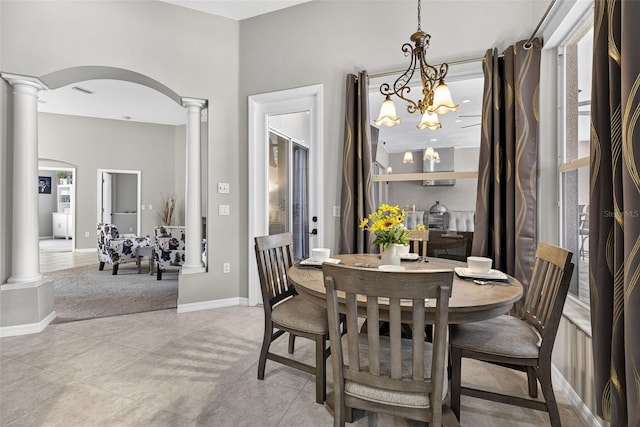 111 Falling Water Dr, Brandon, FL 33511 - dining room with ornate columns, arched walkways, and a chandelier