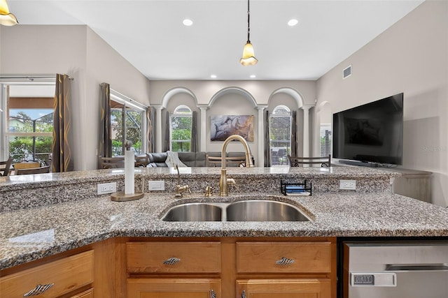 111 Falling Water Dr, Brandon, FL 33511 - kitchen with open floor plan, decorative columns, light stone countertops, healthy amount of natural light, and recessed lighting