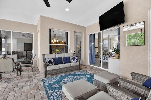 111 Falling Water Dr, Brandon, FL 33511 - living area featuring ceiling fan, a textured wall, and brick flooring
