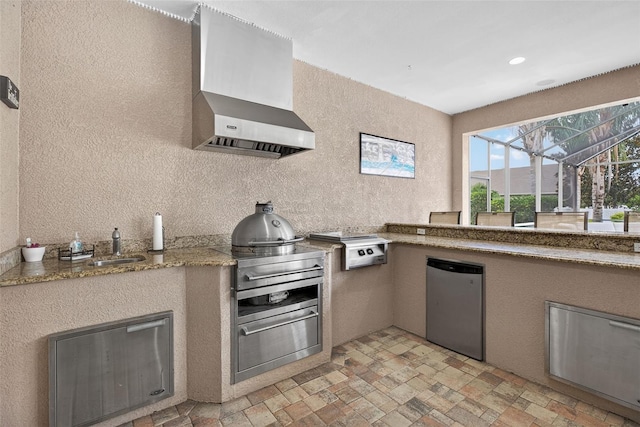 111 Falling Water Dr, Brandon, FL 33511 - kitchen featuring wall chimney range hood, refrigerator, oven, a textured wall, and light stone finish floors