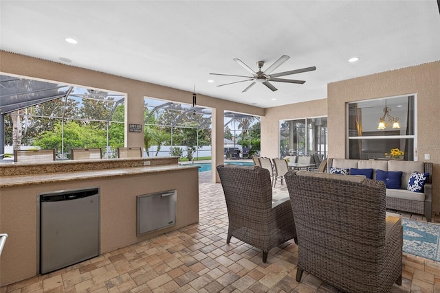 111 Falling Water Dr, Brandon, FL 33511 - view of patio featuring an outdoor living space, an outdoor pool, a ceiling fan, a lanai, and an outdoor kitchen