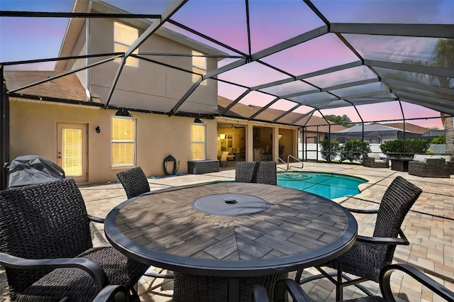 111 Falling Water Dr, Brandon, FL 33511 - pool at dusk with a patio area, outdoor dining space, an outdoor pool, glass enclosure, and grilling area