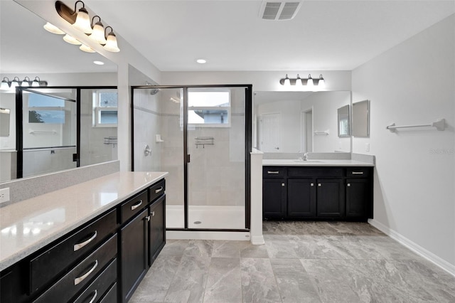19238 Old Spanish Rd, Tampa, FL 33647 - bathroom featuring two vanities, a stall shower, baseboards, and recessed lighting