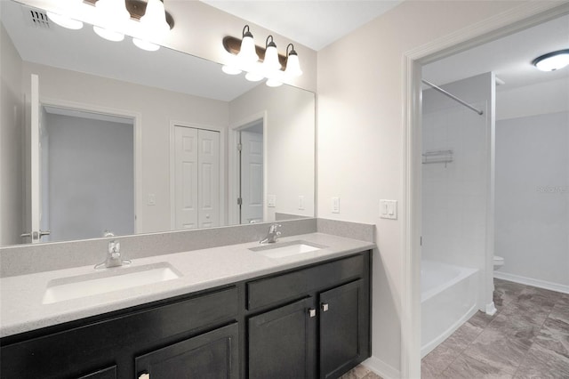 19238 Old Spanish Rd, Tampa, FL 33647 - bathroom featuring double vanity, shower / washtub combination, toilet, and baseboards