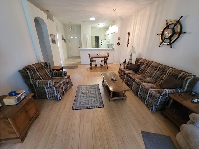 611 Tremont Greens Ln, Sun City Center, FL 33573 - living room with light wood-style flooring and arched walkways