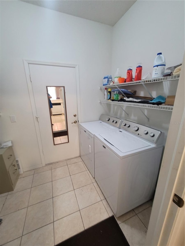 611 Tremont Greens Ln, Sun City Center, FL 33573 - washroom with washer and dryer and light tile patterned flooring