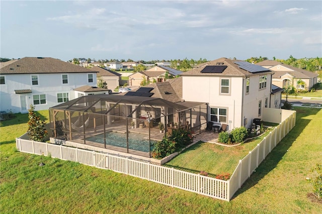 3091 King Fern Dr, Wimauma, FL 33598 - back of property featuring a residential view, a patio, a lanai, and solar panels