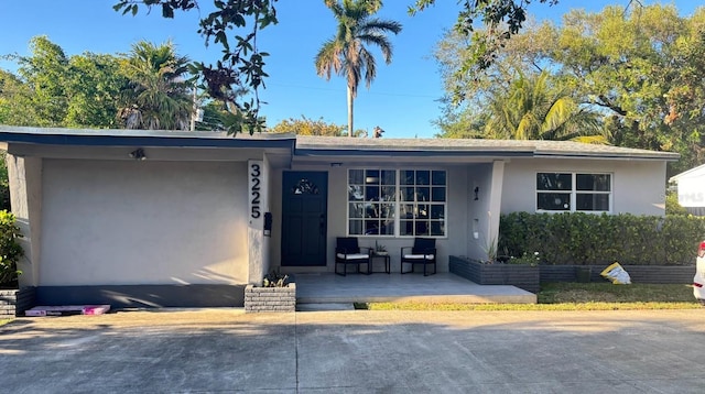 3225 Johnson St, Hollywood, FL 33021 - view of front of property featuring stucco siding and covered porch