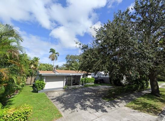 3225 Johnson St, Hollywood, FL 33021 - view of front of house featuring driveway and a front lawn