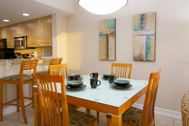 11605 Gulf Blvd Unit 506, Saint Petersburg, FL 33706 - dining space featuring recessed lighting, light tile patterned floors, and baseboards