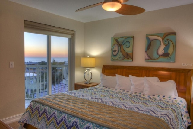 11605 Gulf Blvd Unit 506, Saint Petersburg, FL 33706 - bedroom featuring access to exterior, ceiling fan, and a water view