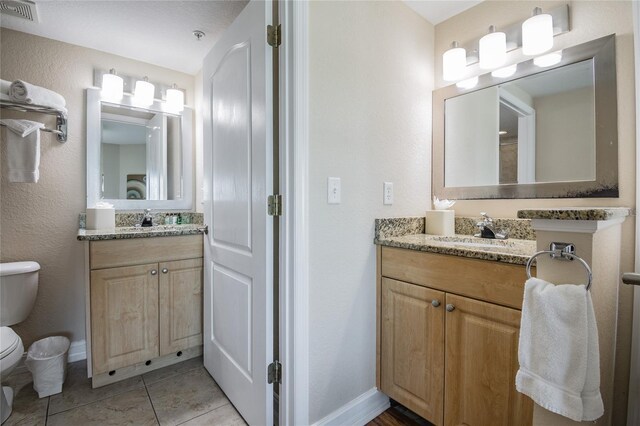 11605 Gulf Blvd Unit 506, Saint Petersburg, FL 33706 - full bathroom featuring toilet, vanity, baseboards, and tile patterned floors