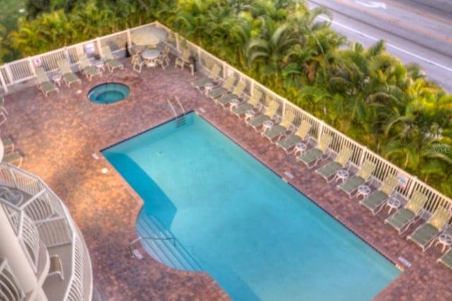 11605 Gulf Blvd Unit 506, Saint Petersburg, FL 33706 - community pool featuring a community hot tub and a patio area
