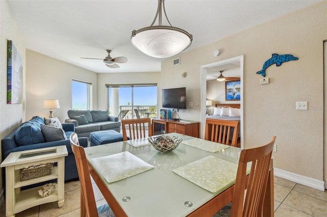 11605 Gulf Blvd Unit 506, Saint Petersburg, FL 33706 - dining space with a ceiling fan, light tile patterned floors, and baseboards